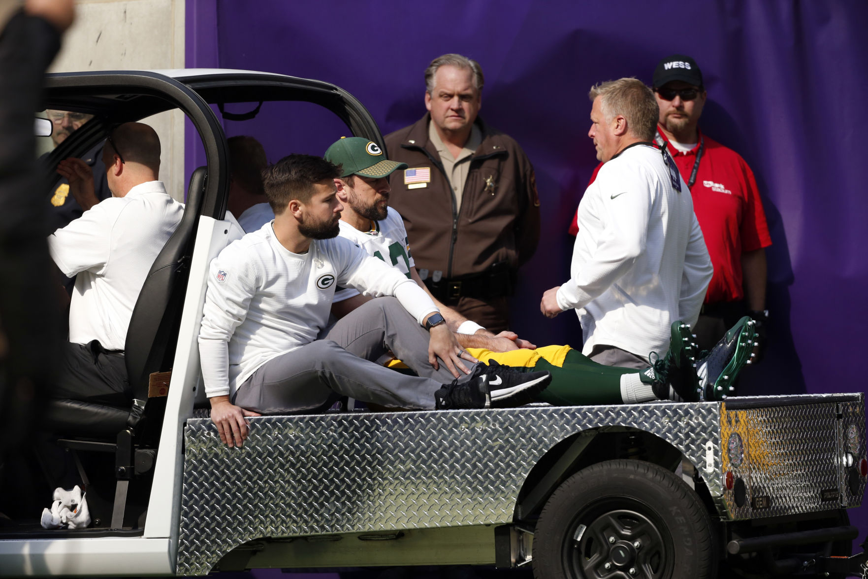 Aaron Rodgers carted off field, AP photo